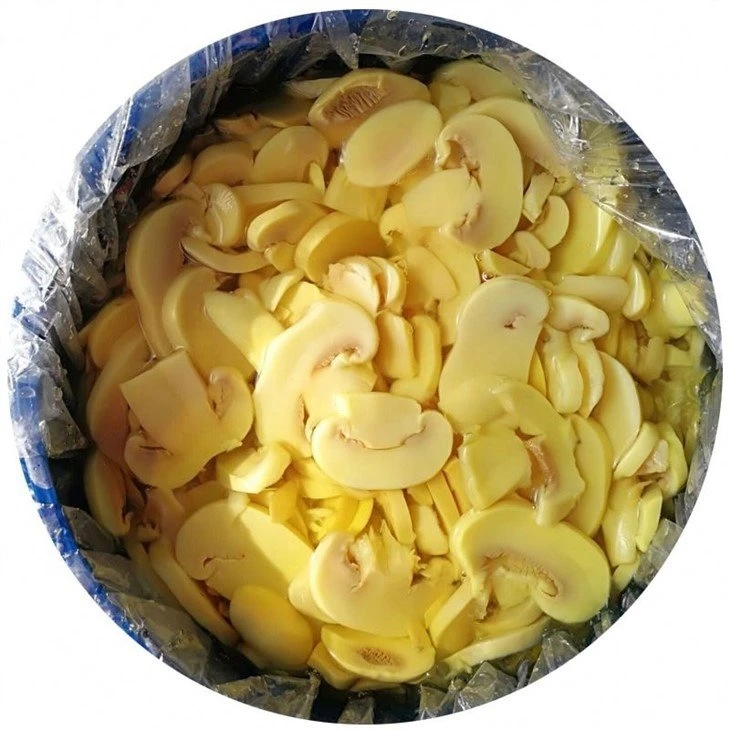 White mushroom sliced in salted water in drums